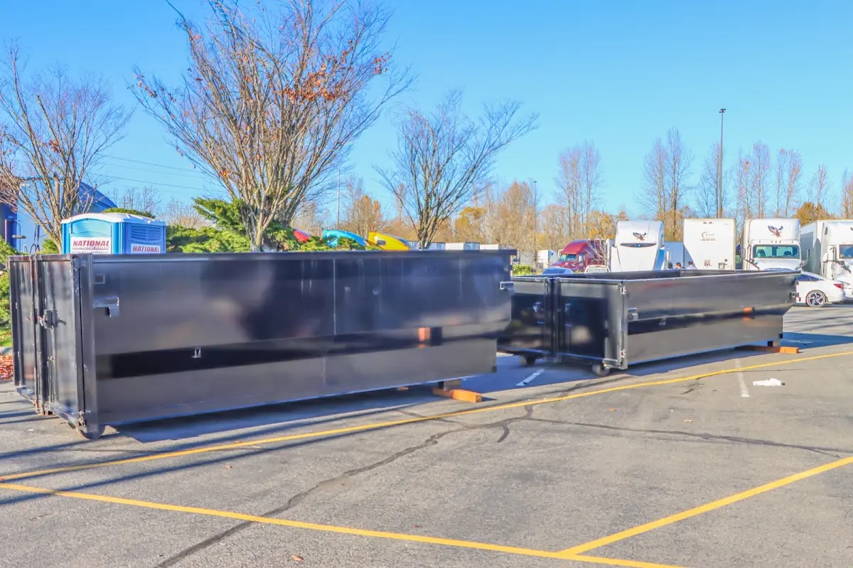 Professional dumpster rental service with roll-off container on residential driveway in Lauderhill